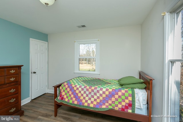 bedroom with dark hardwood / wood-style floors