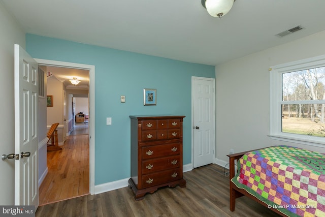 bedroom with dark wood-type flooring