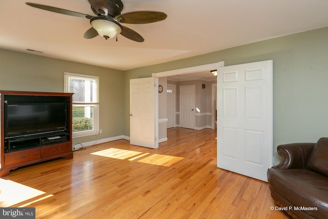 living room with ceiling fan and light wood-type flooring