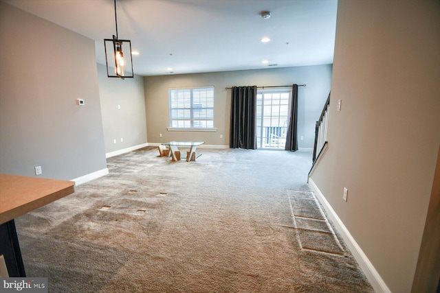 unfurnished living room featuring carpet