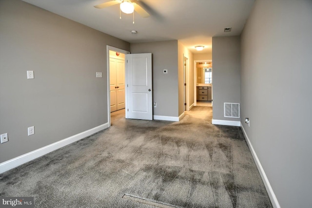 carpeted spare room featuring ceiling fan