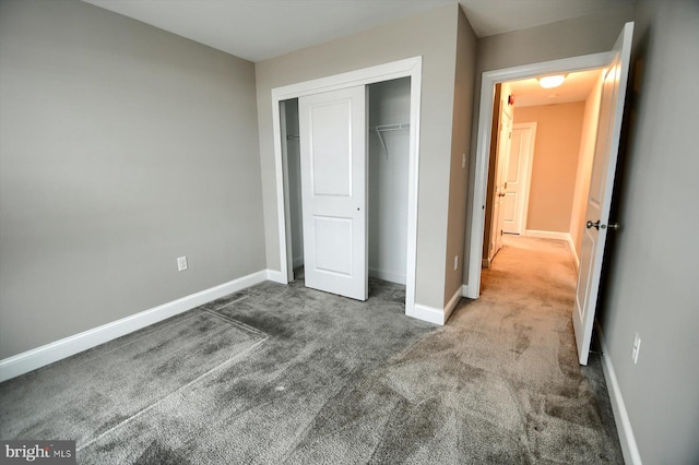 unfurnished bedroom featuring carpet floors and a closet