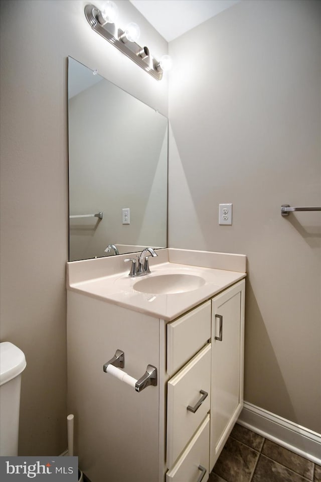 bathroom with vanity, tile patterned floors, and toilet