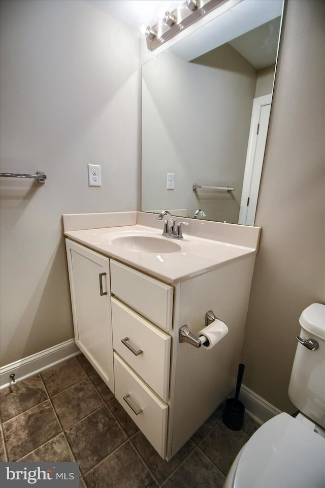 bathroom featuring vanity and toilet