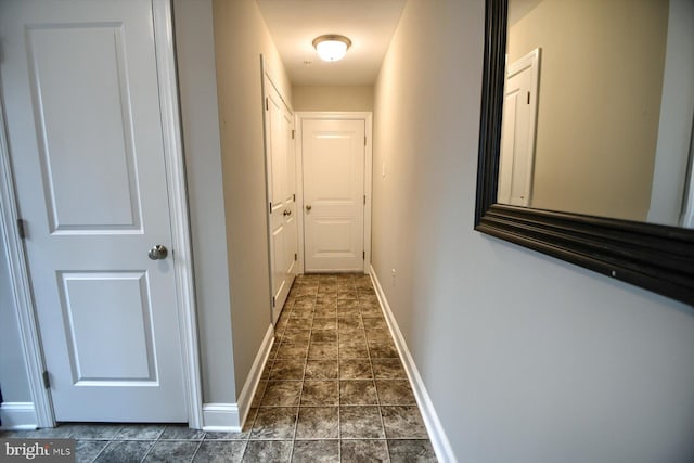 corridor with dark tile patterned floors