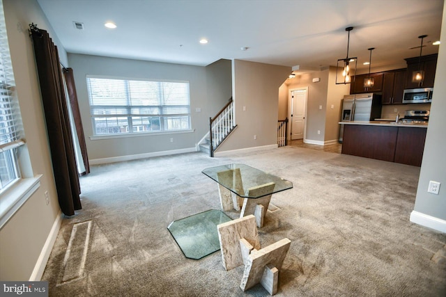 unfurnished living room with light colored carpet