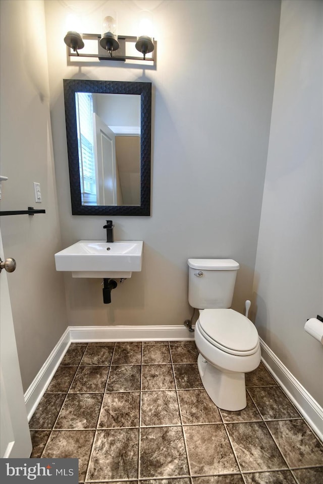 bathroom featuring sink, tile patterned floors, and toilet