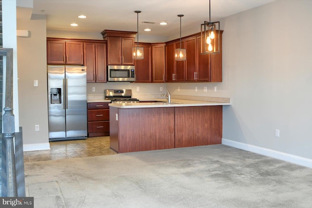 kitchen featuring pendant lighting, stainless steel appliances, kitchen peninsula, and light carpet