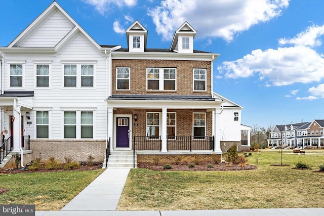 multi unit property with a front yard and covered porch