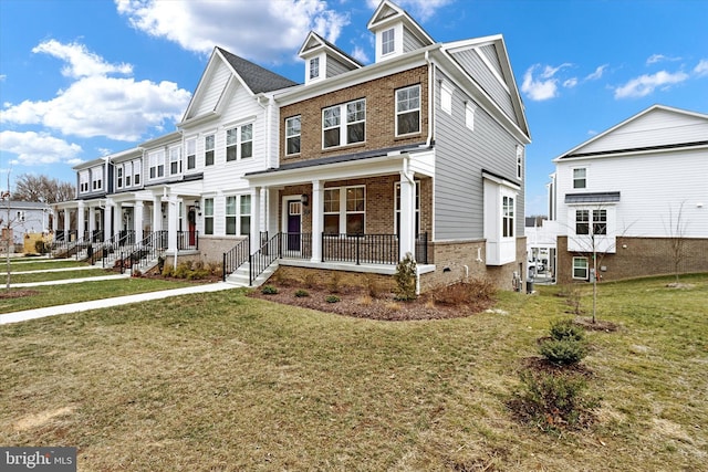 multi unit property featuring covered porch and a front lawn