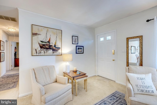 sitting room featuring visible vents, light carpet, attic access, and baseboards