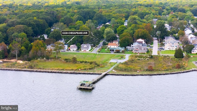 birds eye view of property featuring a water view, a forest view, and a residential view