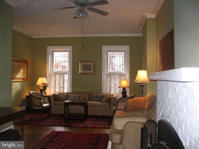 living room with crown molding, ceiling fan, and wood-type flooring