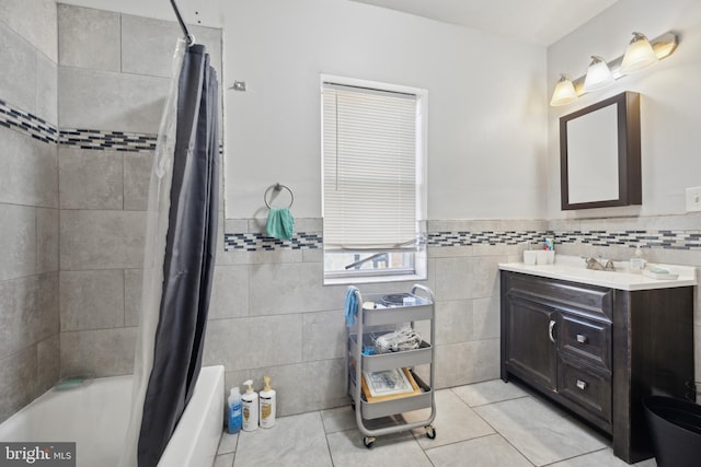 bathroom with vanity, tile walls, shower / tub combo with curtain, and tile patterned floors