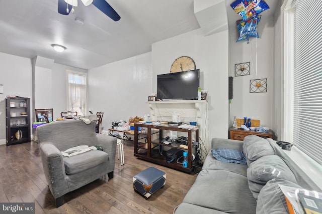 living room featuring dark hardwood / wood-style flooring and ceiling fan