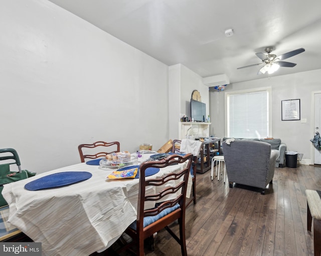 dining room with dark wood-type flooring and ceiling fan