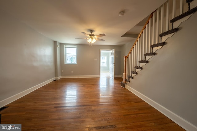 interior space with dark wood-type flooring and ceiling fan