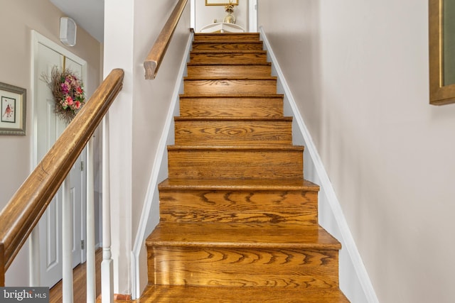 stairway featuring baseboards