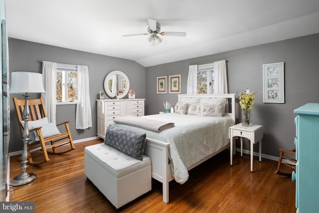 bedroom featuring lofted ceiling, wood finished floors, and baseboards