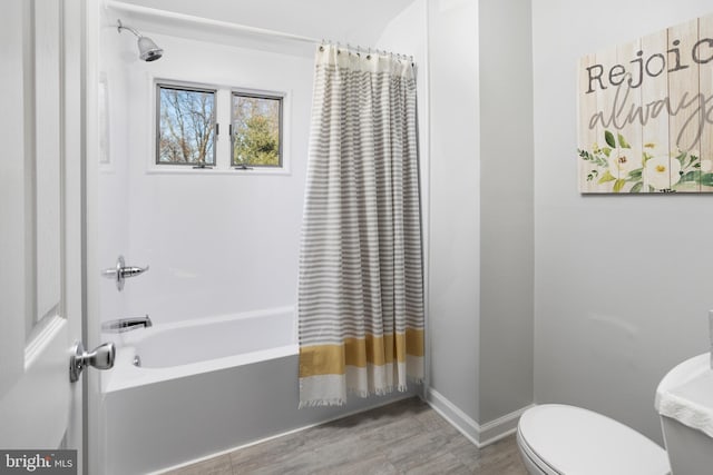 bathroom with shower / bath combination with curtain, toilet, and baseboards