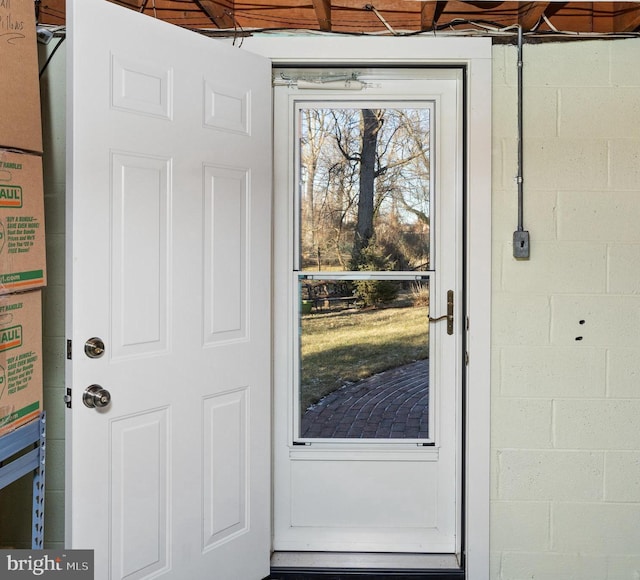 entrance to property featuring concrete block siding