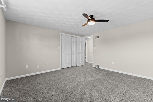 unfurnished bedroom featuring ceiling fan, a closet, carpet, and a textured ceiling