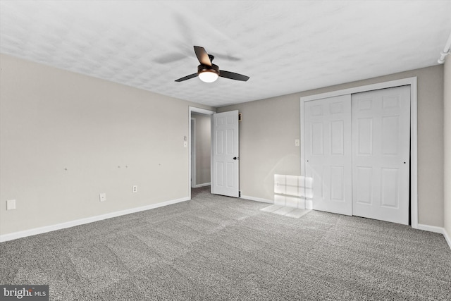 unfurnished bedroom with ceiling fan, a closet, and carpet