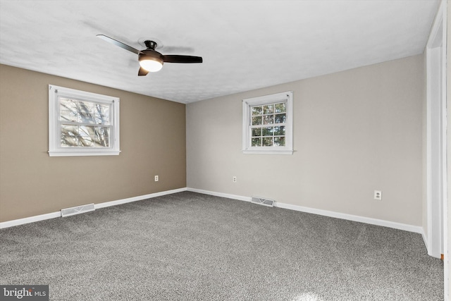 carpeted spare room with ceiling fan