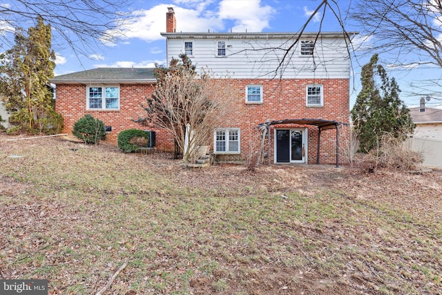 back of house featuring a pergola and a yard