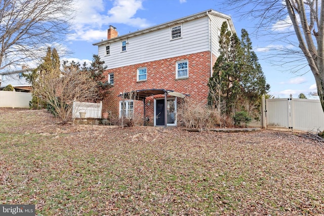 rear view of property with a pergola