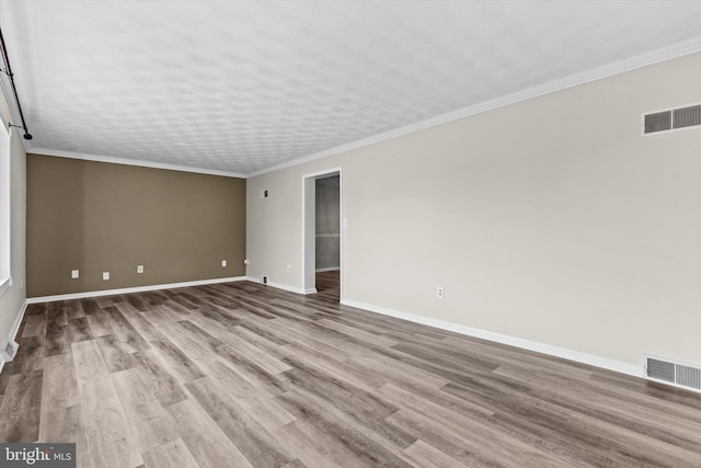 unfurnished room with crown molding and light hardwood / wood-style floors