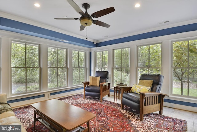 sunroom featuring ceiling fan and a wealth of natural light