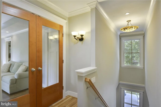 doorway with french doors, ornamental molding, and hardwood / wood-style flooring