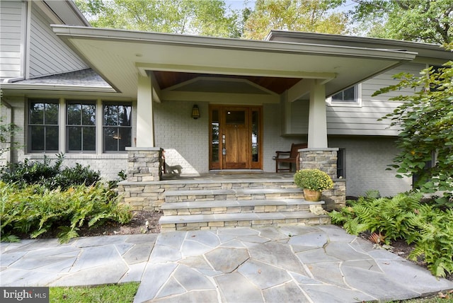 property entrance featuring a porch