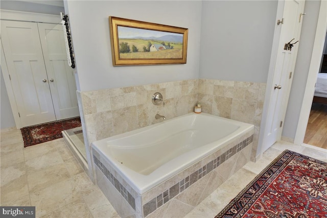 bathroom with tiled tub