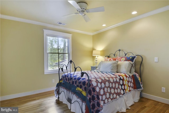 bedroom featuring ornamental molding, hardwood / wood-style floors, and ceiling fan