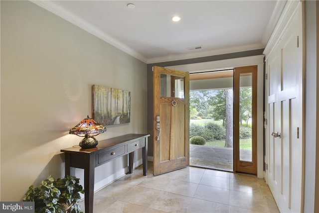 entrance foyer featuring ornamental molding and light tile patterned floors