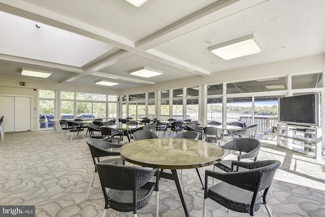 dining room with coffered ceiling and beam ceiling