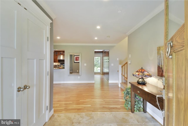 corridor featuring crown molding and light hardwood / wood-style floors