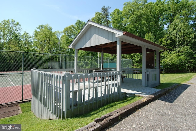 surrounding community with a gazebo, a yard, and tennis court