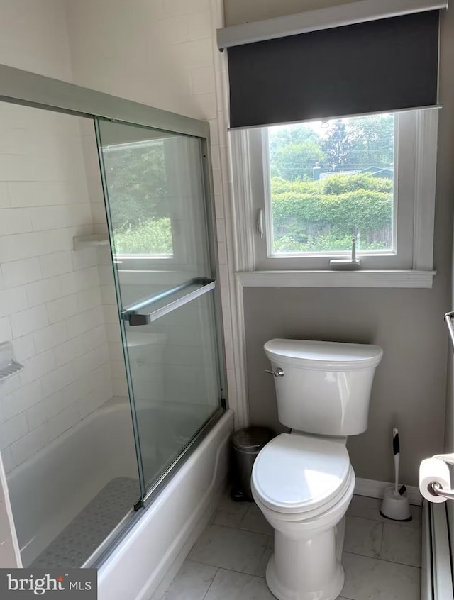 bathroom with marble finish floor, baseboards, toilet, and bath / shower combo with glass door