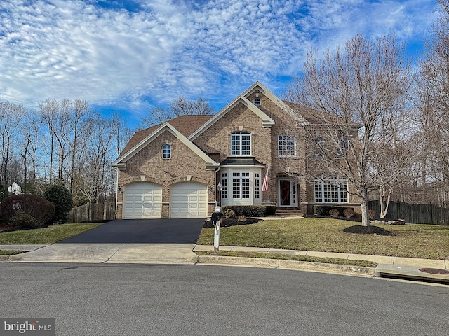 view of front of home featuring a garage and a front lawn