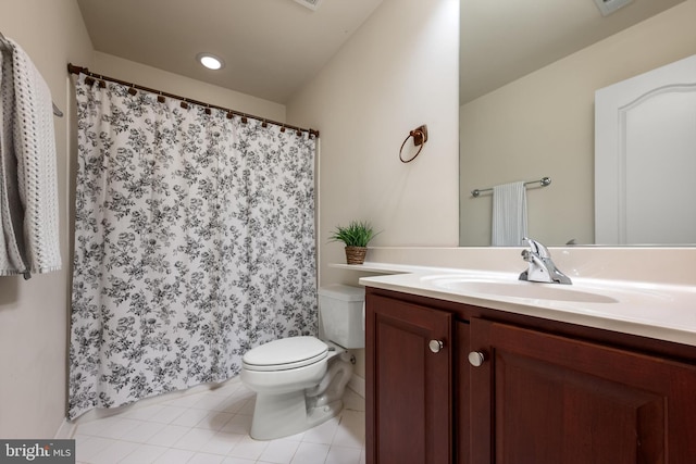 bathroom featuring vanity, tile patterned flooring, and toilet