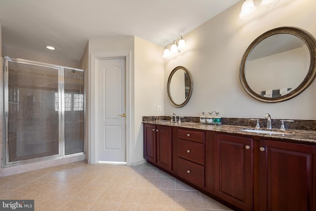 bathroom featuring vanity, a shower with door, and tile patterned floors