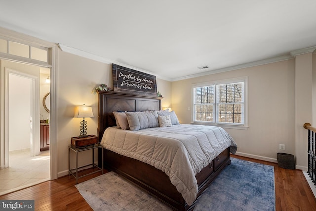 bedroom with crown molding and dark wood-type flooring