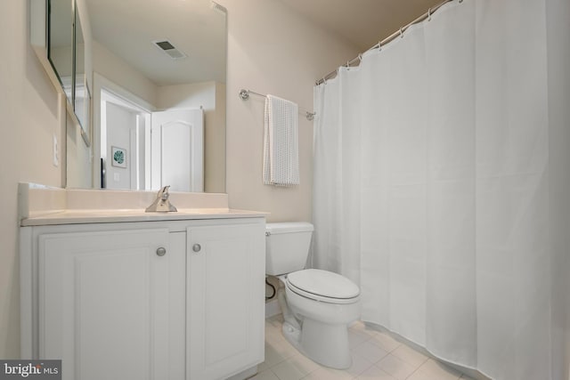 bathroom with tile patterned floors, toilet, and vanity