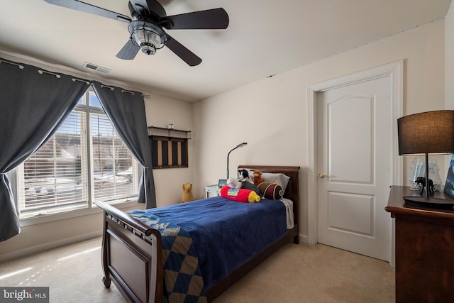 bedroom featuring light carpet and ceiling fan