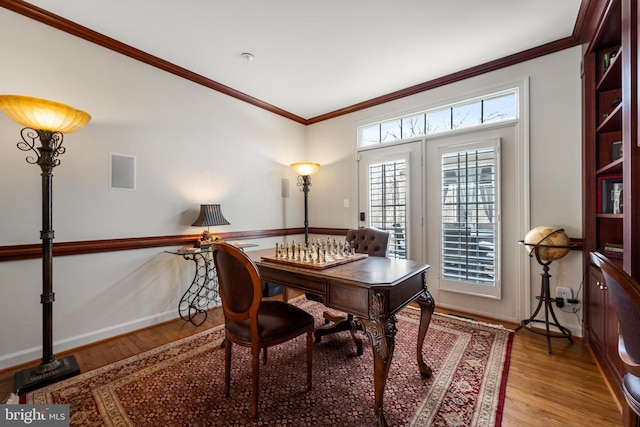 home office featuring crown molding and light hardwood / wood-style floors