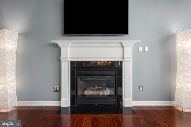 interior details featuring hardwood / wood-style flooring