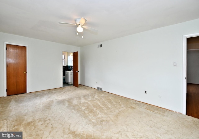 unfurnished bedroom featuring light colored carpet and ceiling fan